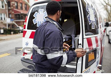 Mixed race paramedic opening ambulance View Large Photo Image Stock Photo - Mixed race paramedic opening ambulance. Fotosearch