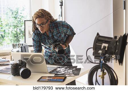 Mixed race photographer using laptop in studio View Large Photo Image Stock Image - Mixed race photographer using laptop in studio. Fotosearch