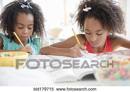Mixed race sisters doing homework View Large Photo Image Stock Photography - Mixed race sisters doing homework. Fotosearch