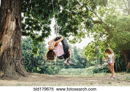 Mixed race sisters playing in backyard View Large Photo Image Stock Photography - Mixed race sisters playing in backyard. Fotosearch