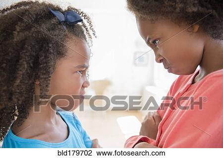 Mixed race sisters scowling View Large Photo Image Stock Image - Mixed race sisters scowling. Fotosearch