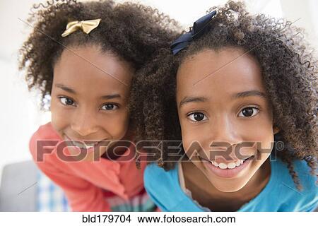 Mixed race sisters smiling View Large Photo Image Picture - Mixed race sisters smiling. Fotosearch
