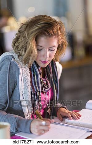 Mixed race student studying at table View Large Photo Image Stock Image - Mixed race student studying at table. Fotosearch