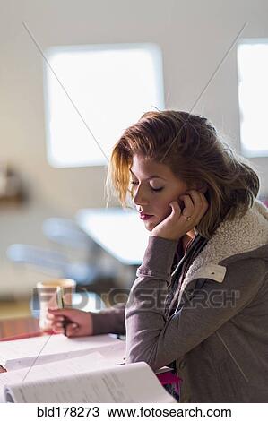 Mixed race student studying at table View Large Photo Image Stock Image - Mixed race student studying at table. Fotosearch