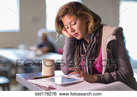 Mixed race student studying at table View Large Photo Image Stock Photograph - Mixed race student studying at table. Fotosearch