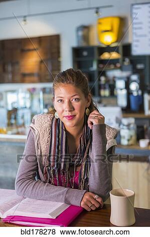 Stock Photo - Mixed race student studying in cafe. Fotosearch