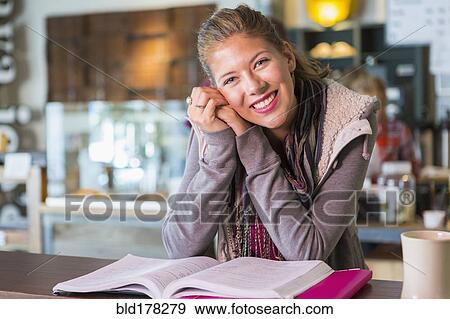 Stock Photo - Mixed race student studying in cafe. Fotosearch