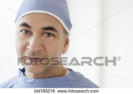 Stock Photograph - Mixed race surgeon wearing scrubs. Fotosearch