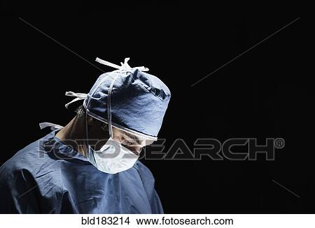 Picture - Mixed race surgeon working in operating room. Fotosearch