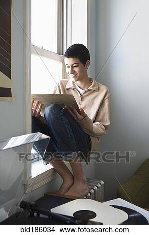 Mixed race teenage boy listening to records View Large Photo Image Picture - Mixed race teenage boy listening to records. Fotosearch