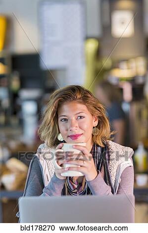 Mixed race teenage girl drinking cup of coffee View Large Photo Image Stock Image - Mixed race teenage girl drinking cup of coffee. Fotosearch