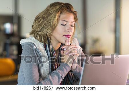 Stock Photo - Mixed race teenage girl using laptop. Fotosearch