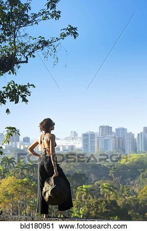 Stock Image - "Mixed race woman admiring cityscape, Rio de Janeiro, Brazil". Fotosearch