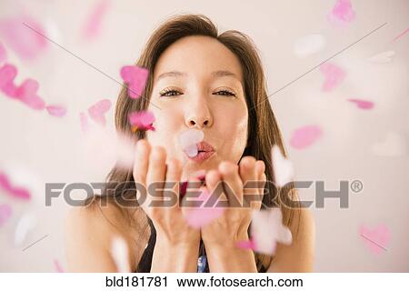 Mixed race woman blowing confetti View Large Photo Image Stock Image - Mixed race woman blowing confetti. Fotosearch