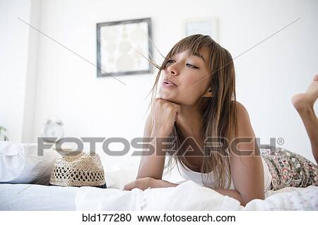 Mixed race woman blowing hair from face View Large Photo Image Stock Image - Mixed race woman blowing hair from face. Fotosearch