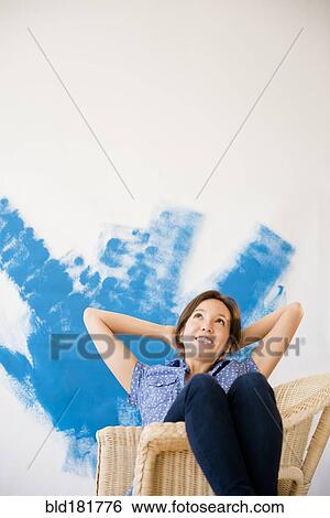 Mixed race woman daydreaming in new home View Large Photo Image Stock Photograph - Mixed race woman daydreaming in new home. Fotosearch