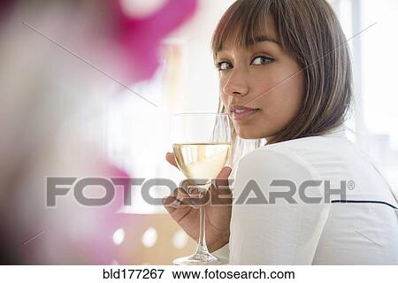 Mixed race woman drinking white wine View Large Photo Image Stock Photo - Mixed race woman drinking white wine. Fotosearch