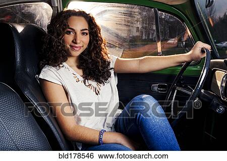 Stock Photograph - Mixed race woman driving car. Fotosearch
