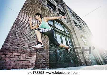 Mixed race woman jogging on sidewalk View Large Photo Image Stock Image - Mixed race woman jogging on sidewalk. Fotosearch