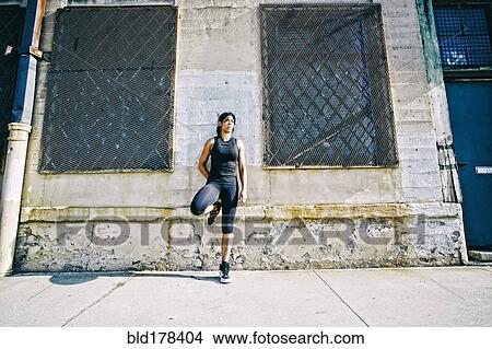 Mixed race woman leaning on wall View Large Photo Image Picture - Mixed race woman leaning on wall. Fotosearch