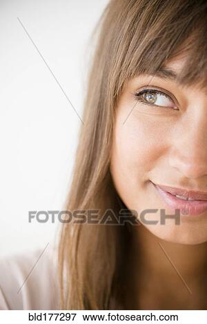 Stock Photo - Mixed race woman looking away. Fotosearch