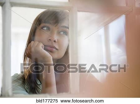 Mixed race woman looking out window View Large Photo Image Stock Photography - Mixed race woman looking out window. Fotosearch