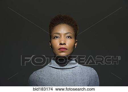 Picture - Mixed race woman looking up. Fotosearch
