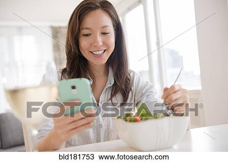 Mixed race woman photographing salad View Large Photo Image Stock Image - Mixed race woman photographing salad. Fotosearch