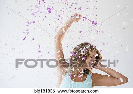 Mixed race woman playing in confetti View Large Photo Image Stock Photography - Mixed race woman playing in confetti. Fotosearch