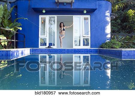 Stock Photo - Mixed race woman reflected in swimming pool. Fotosearch