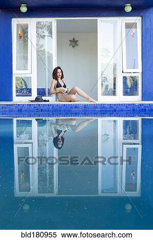 Mixed race woman reflected in swimming pool View Large Photo Image Stock Photography - Mixed race woman reflected in swimming pool. Fotosearch