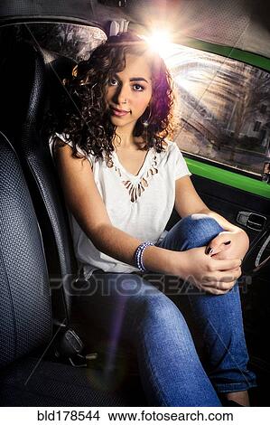 Picture - Mixed race woman sitting in car. Fotosearch