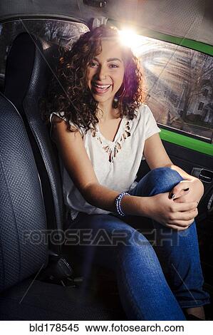 Mixed race woman smiling in car View Large Photo Image Stock Photography - Mixed race woman smiling in car. Fotosearch