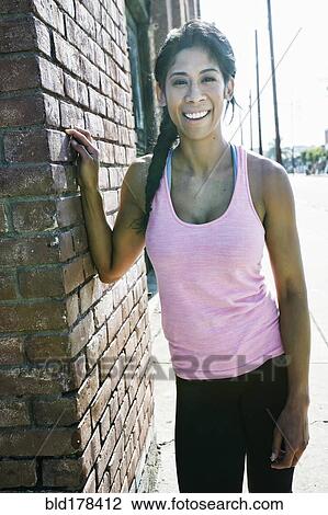 Stock Image - Mixed race woman smiling outdoors. Fotosearch
