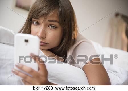 Mixed race woman using cell phone View Large Photo Image Stock Photo - Mixed race woman using cell phone. Fotosearch