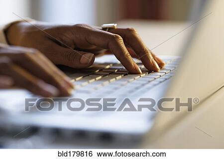 Mixed race woman using laptop at desk View Large Photo Image Stock Photograph - Mixed race woman using laptop at desk. Fotosearch