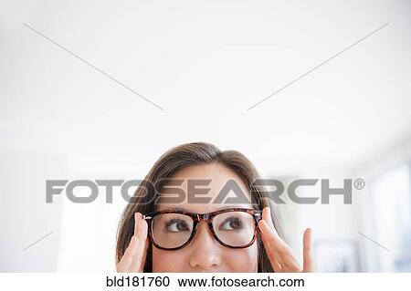 Stock Image - Mixed race woman wearing eyeglasses. Fotosearch