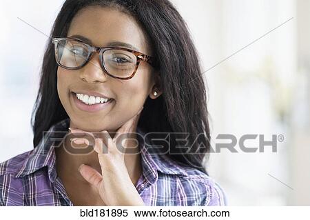 Stock Photography - Mixed race woman wearing eyeglasses. Fotosearch