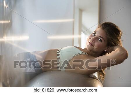 Mixed race woman working out on exercise ball View Large Photo Image Stock Photograph - Mixed race woman working out on exercise ball. Fotosearch
