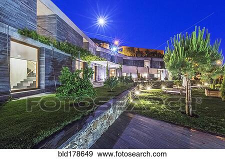 Stock Photo - Modern hotel illuminated at night. Fotosearch
