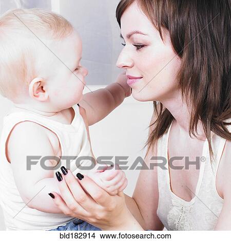 Mother admiring baby son View Large Photo Image Picture - Mother admiring baby son. Fotosearch