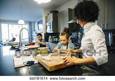 Picture - Mother and children baking in kitchen. Fotosearch