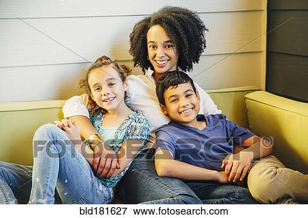 Mother and children relaxing on sofa View Large Photo Image Stock Photo - Mother and children relaxing on sofa. Fotosearch