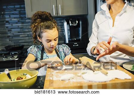 Mother and daughter baking in kitchen View Large Photo Image Stock Image - Mother and daughter baking in kitchen. Fotosearch