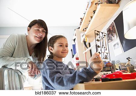 Mother and daughter building model toy View Large Photo Image Stock Photo - Mother and daughter building model toy. Fotosearch