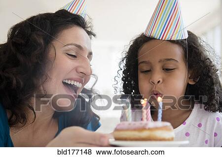Stock Photo - Mother and daughter celebrating birthday. Fotosearch