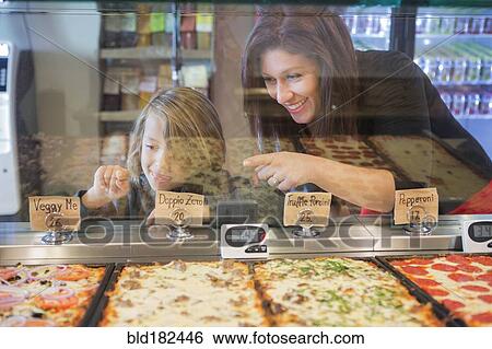 Mother and daughter choosing pizza in cafe View Large Photo Image Stock Photograph - Mother and daughter choosing pizza in cafe. Fotosearch