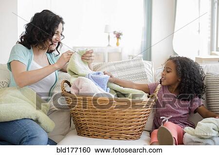 Mother and daughter folding laundry View Large Photo Image Stock Image - Mother and daughter folding laundry. Fotosearch