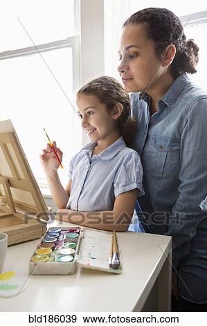 Stock Photo - Mother and daughter painting. Fotosearch