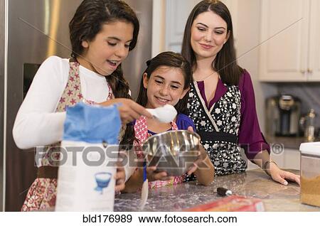 Mother and daughters baking in kitchen View Large Photo Image Stock Photo - Mother and daughters baking in kitchen. Fotosearch